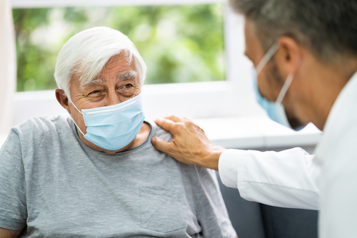 Doctor with hand on patient's shoulder